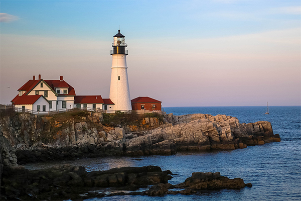 House on coast with lighthouse