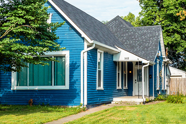 blue house with green grass