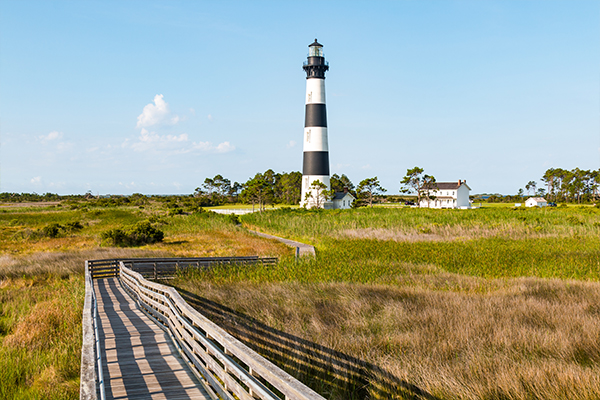 Boardwalk to lighthouse on a sunny day