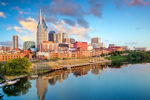 Skylin of Nashville reflecting on the river with blue skies