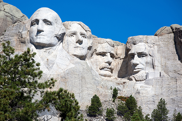 Mount Rushmore with blue skies and greenery