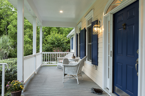 Southern front porch with chairs and blue door