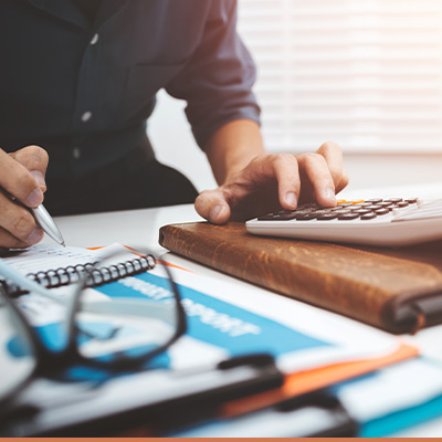 Close up of man using calculator