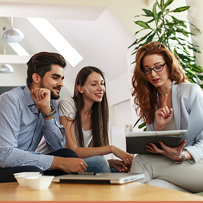 Realtor teaching young happy couple