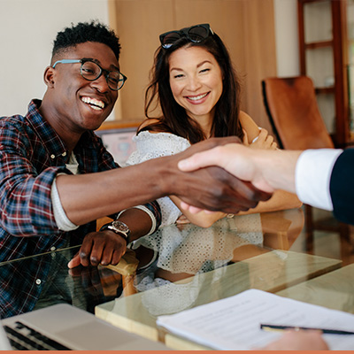 Young couple shaking hands with lender