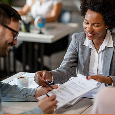 Realtor explaining mortgage options to client at desk