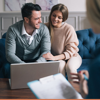 Young couple meeting with realtor in living room