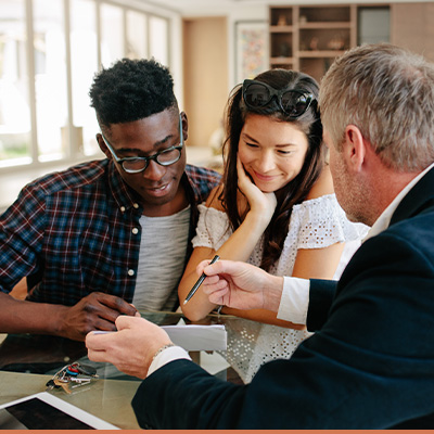 Young inter-racial couple meeting with realtor