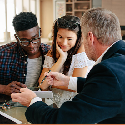 Couple reviewing paperwork with realtor