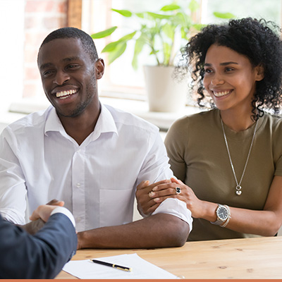 Young couple shaking hands with realtor