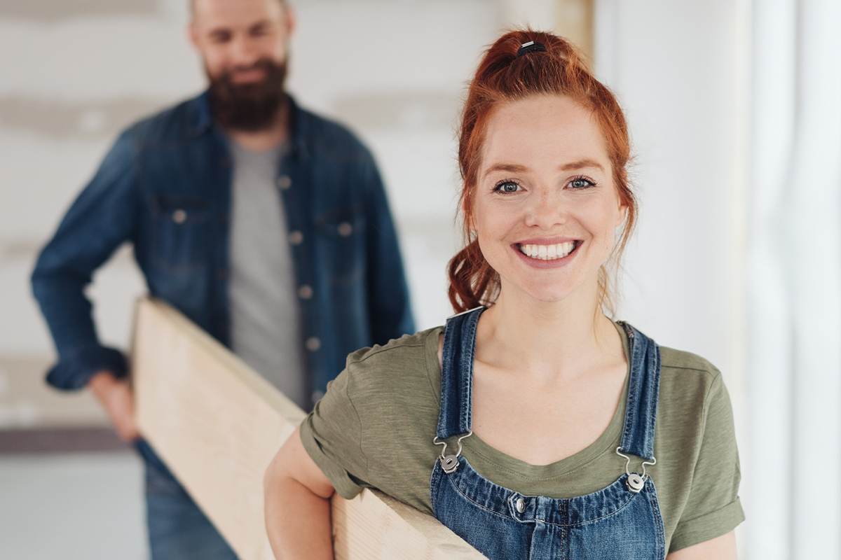 woman holding lumber