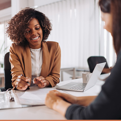 Realtor meeting with client reviewing paperwork