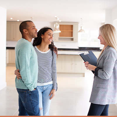 Young couple looking at a home with realtor