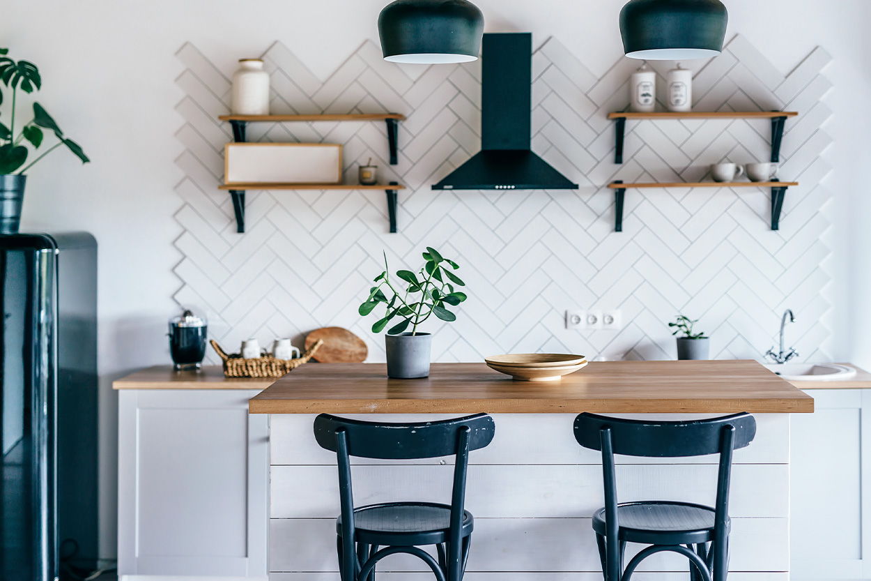 Renovated kitchen with white tile and black hardware