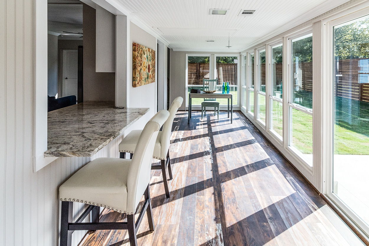 Remodeled porch with hardwood and tall windows