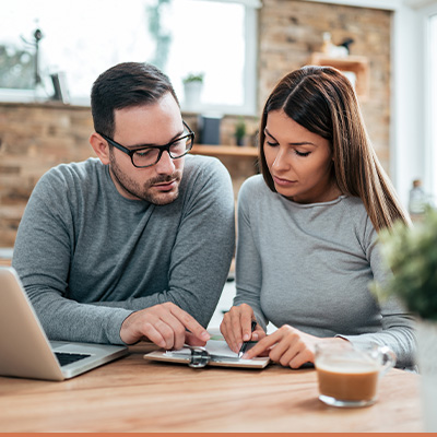 Couple at table reviewing paperwork