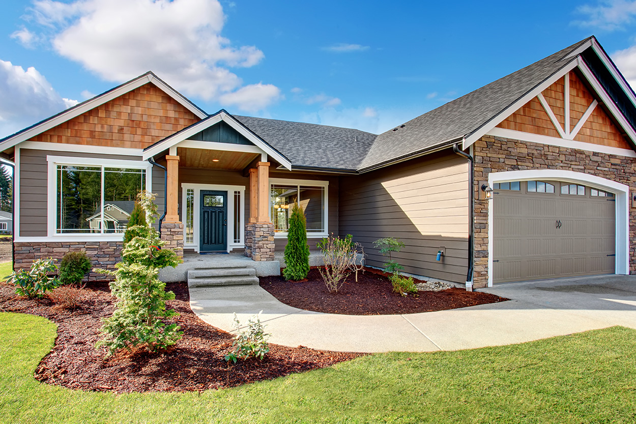 Exterior new build house with well landscaped yard