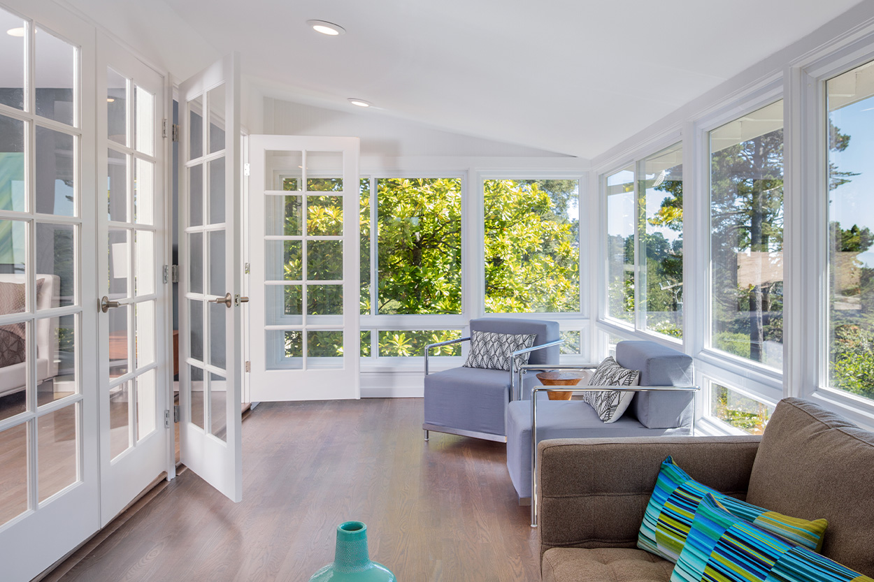 Remodeled Sunroom with tall white trim windows