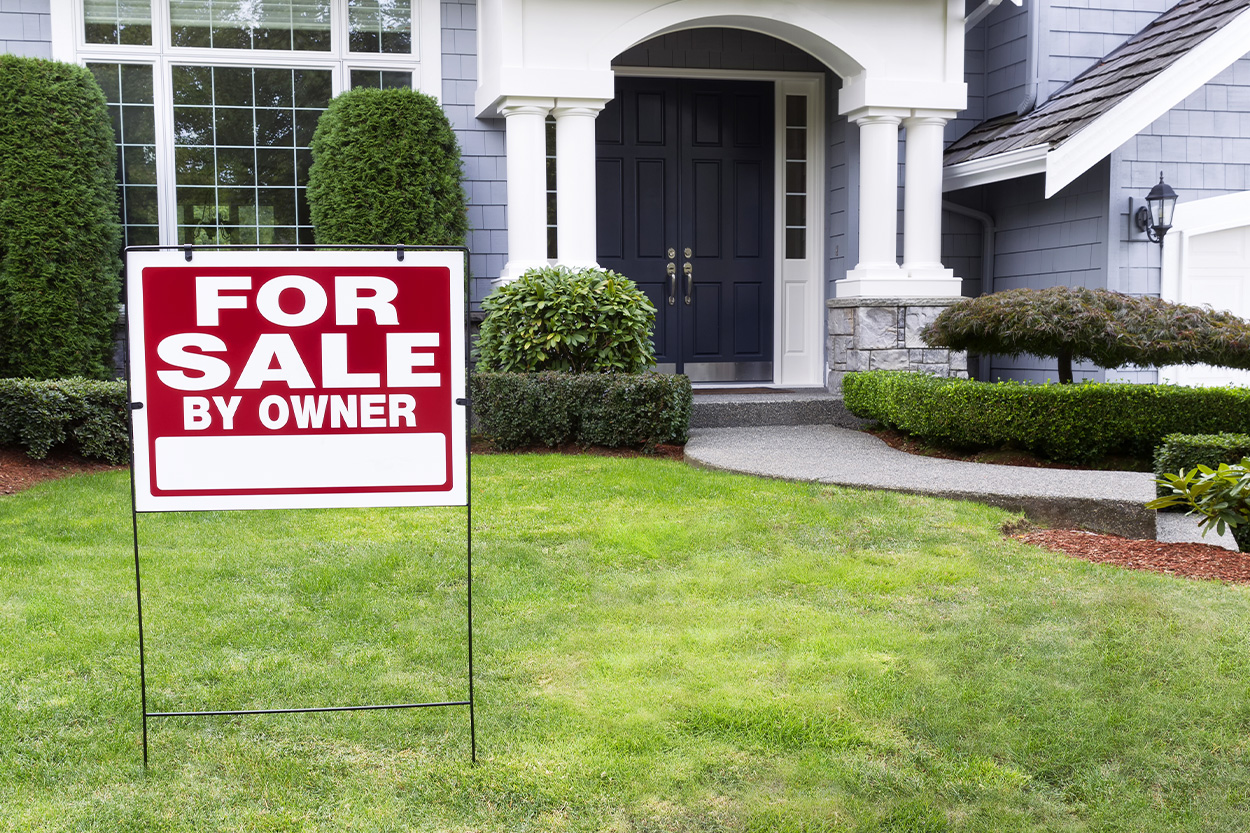 For sale by owner sign in front lawn