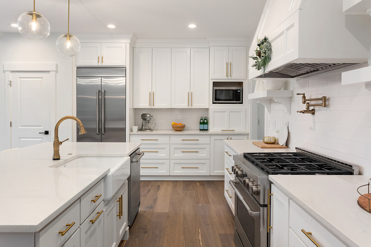 kitchen with hardwood floors and white cabinets and countertops