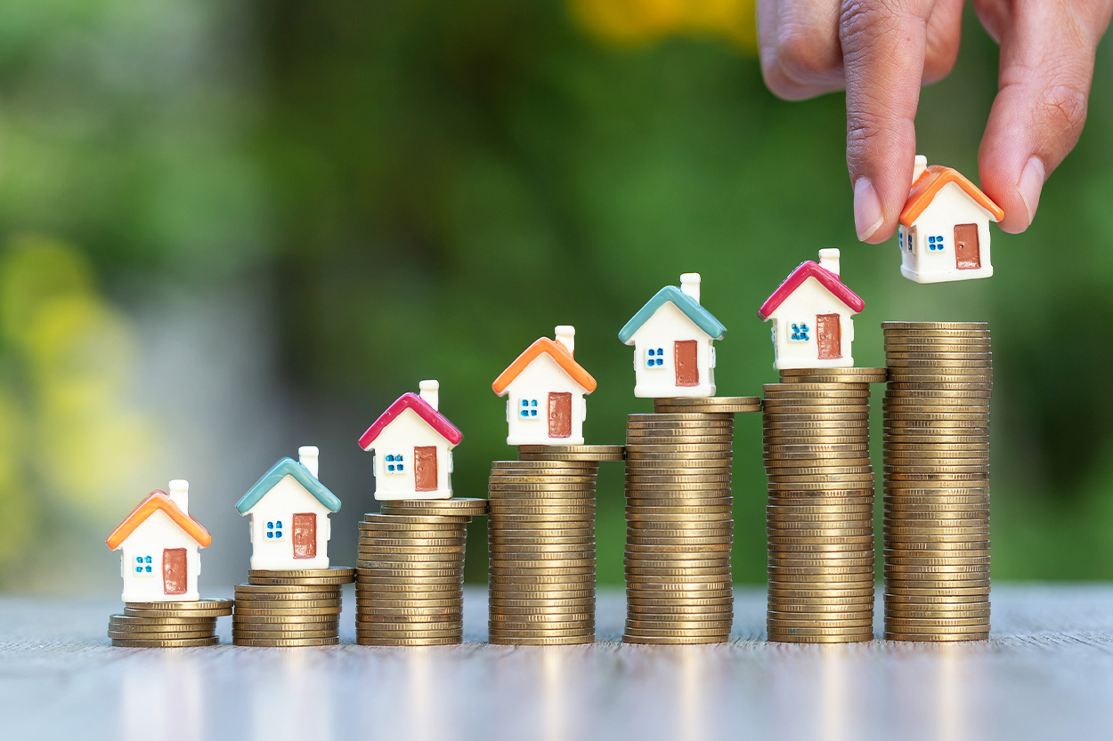 stacked coins with houses on top