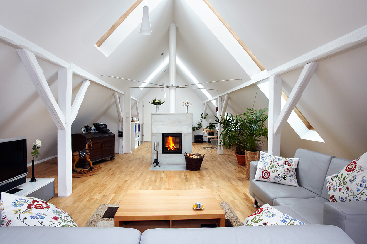 Remodeled attic with exposed beams and hardwood floors