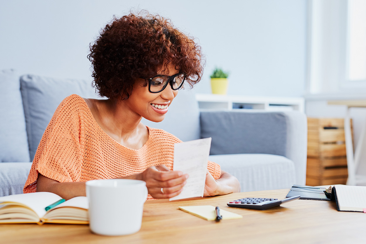 Young woman reviewing finances at table